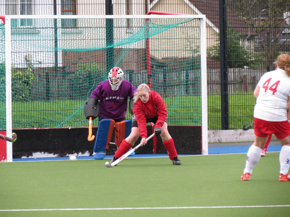 Defender Nina Wells bravely deflects a shot wide